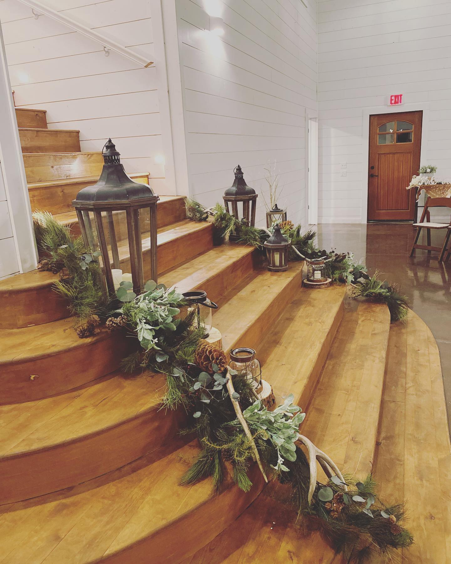 stairs decorated with greenery and lights