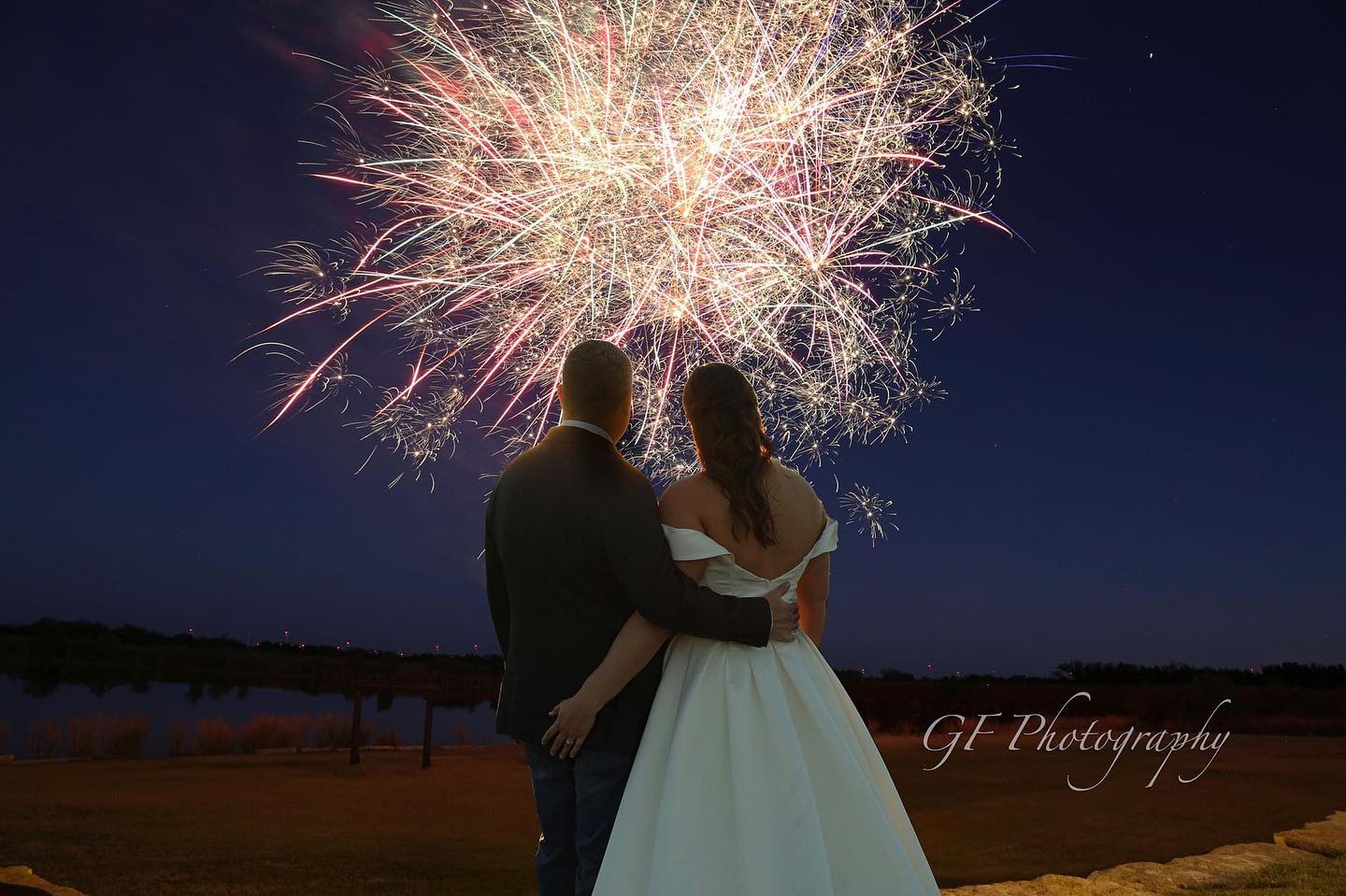 bride and groom watching fireworks