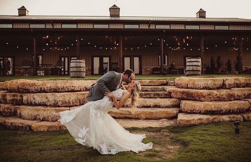 bride and groom kissing in front of building
