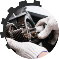 A person wearing white gloves is working on a gear | Cincinnati Transmission Specialists & Sharon Woods Auto Care
