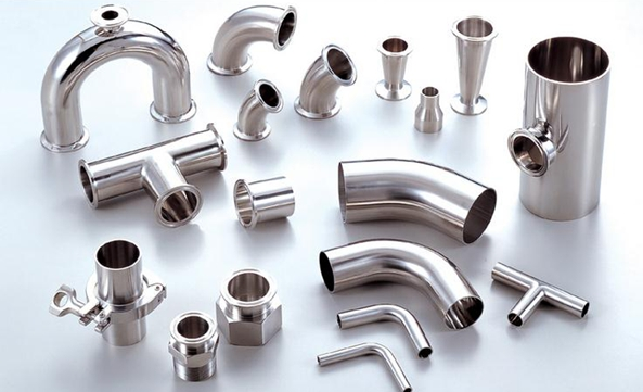 There are many different types of metal pipe fittings on the table