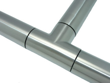 A table topped with a variety of stainless steel pipe fittings.