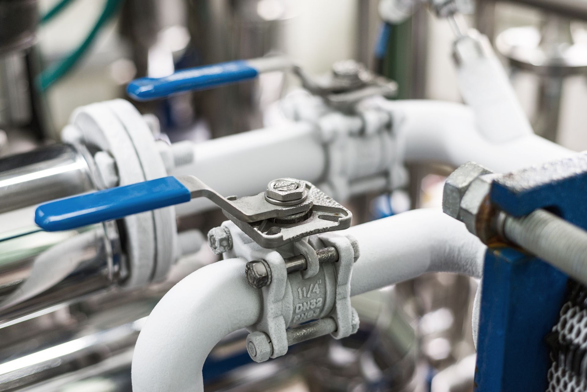 A close up of a valve on a pipe in a factory