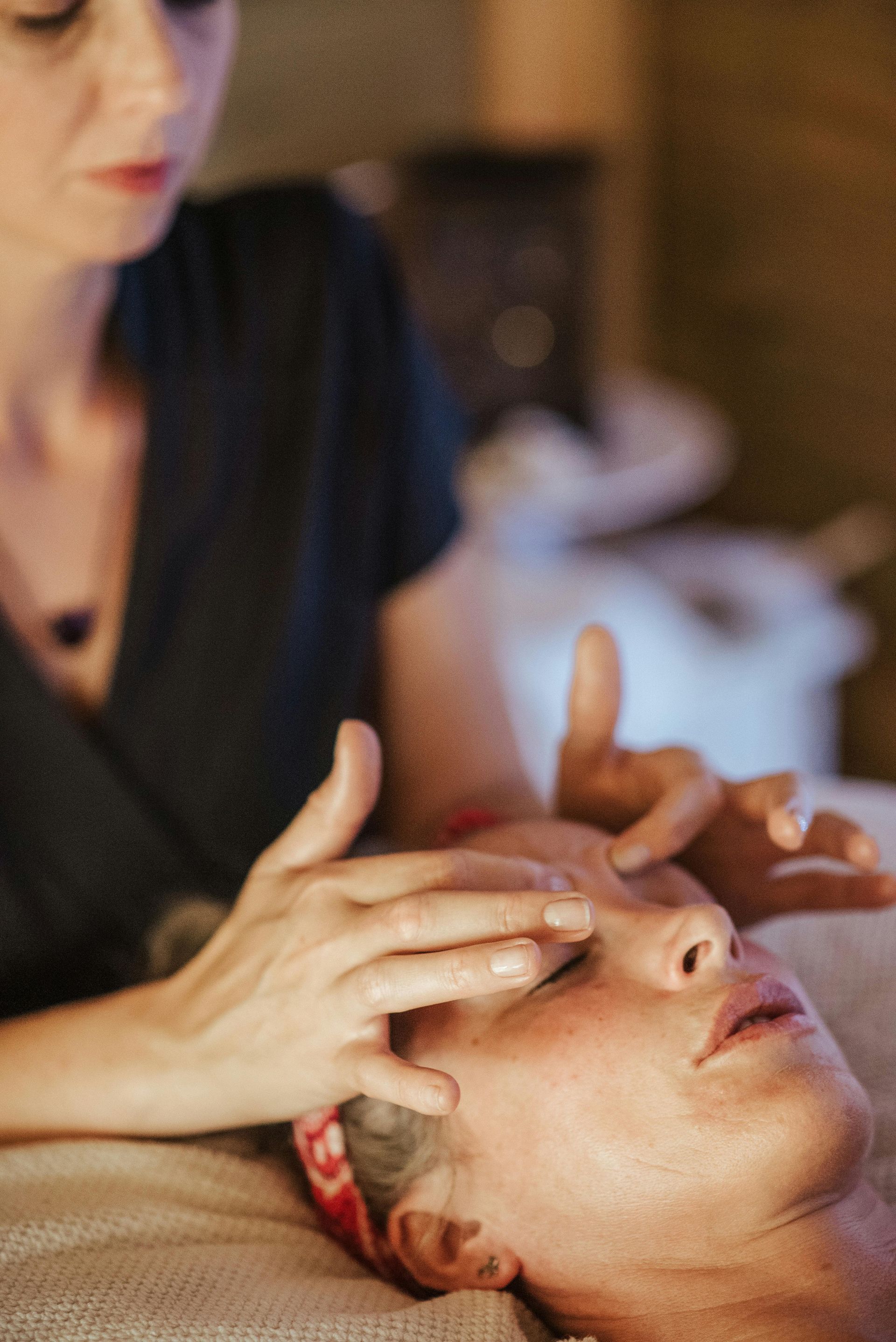 A woman is getting a massage on her face at a spa.