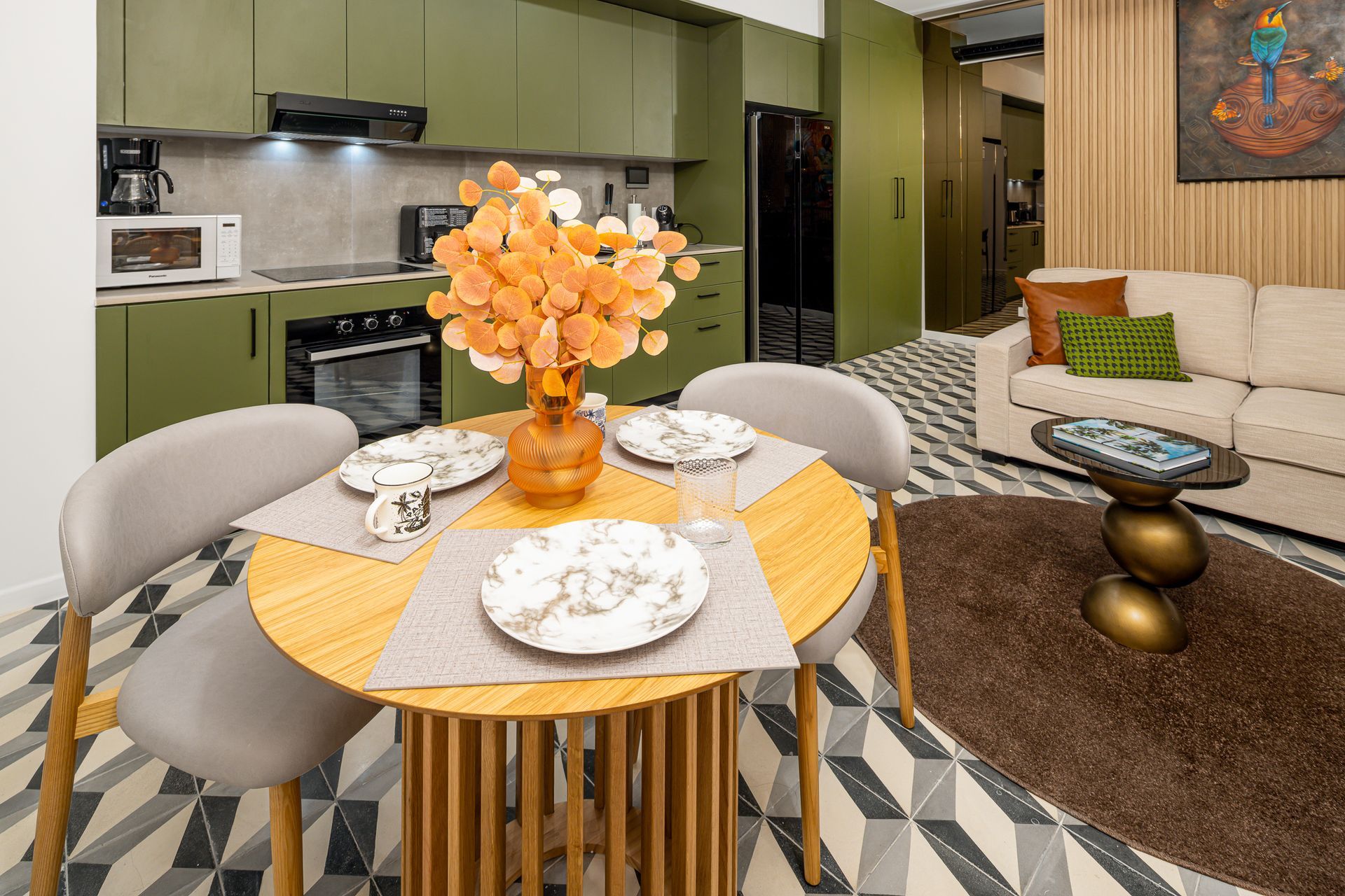 Modern apartment interior with kitchen, dining area, and living room in olive green and beige tones. real estate photos by ivan marquez panama