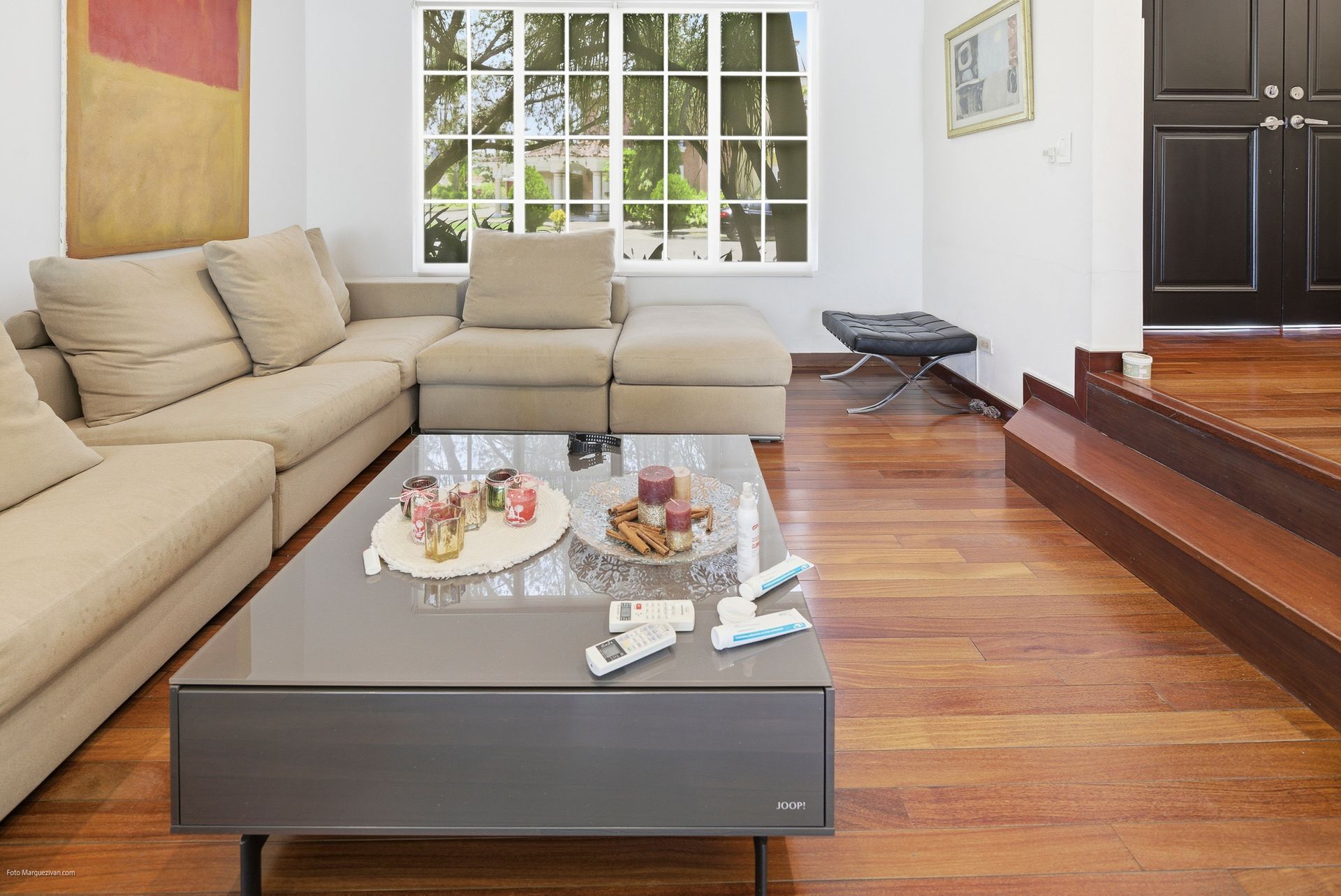 Costa del Este secondary living area with beige sofa and modern coffee table, Panama luxury real estate.
