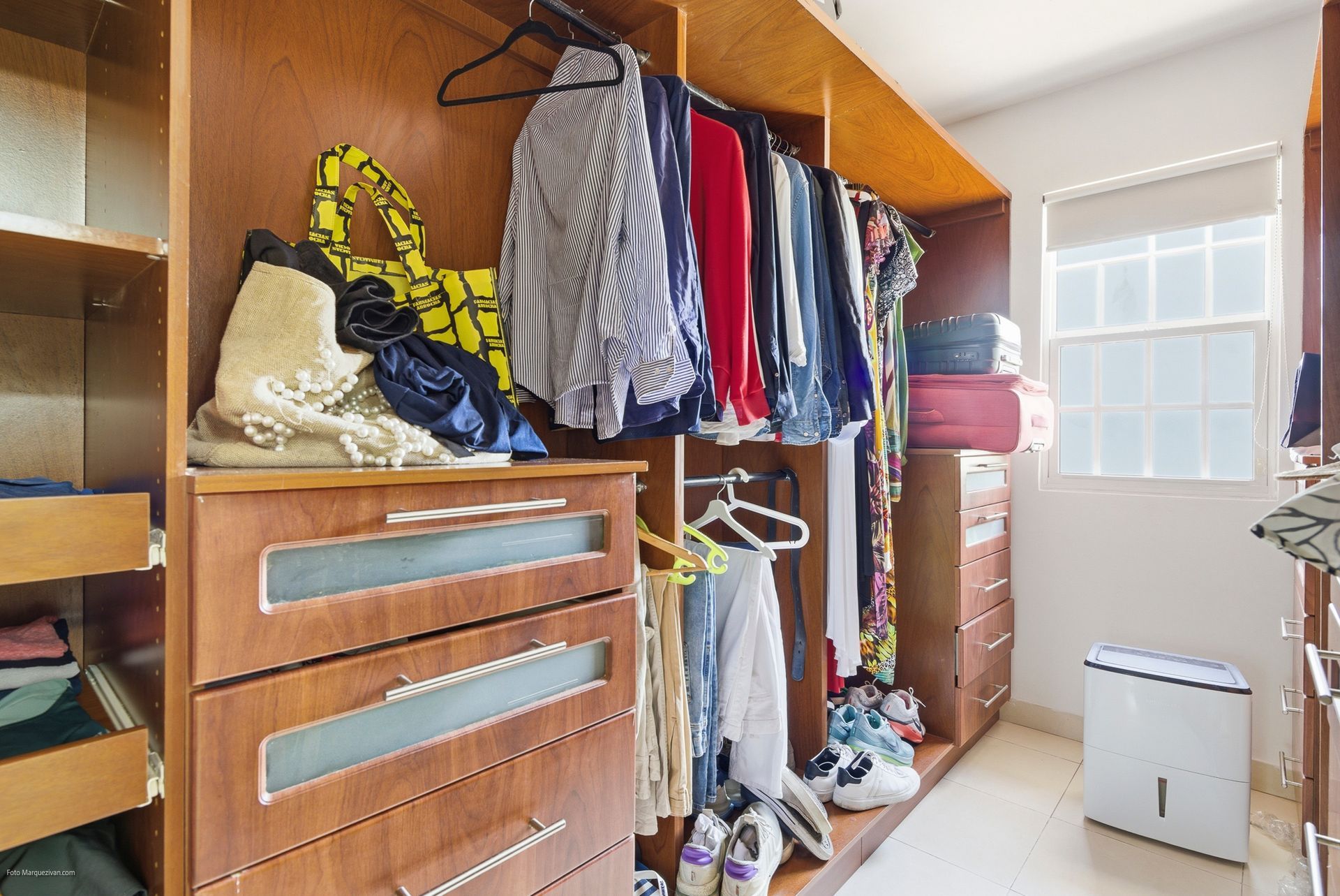Costa del Este master suite walk-in closet as captured before digital declutter, Panama luxury home.