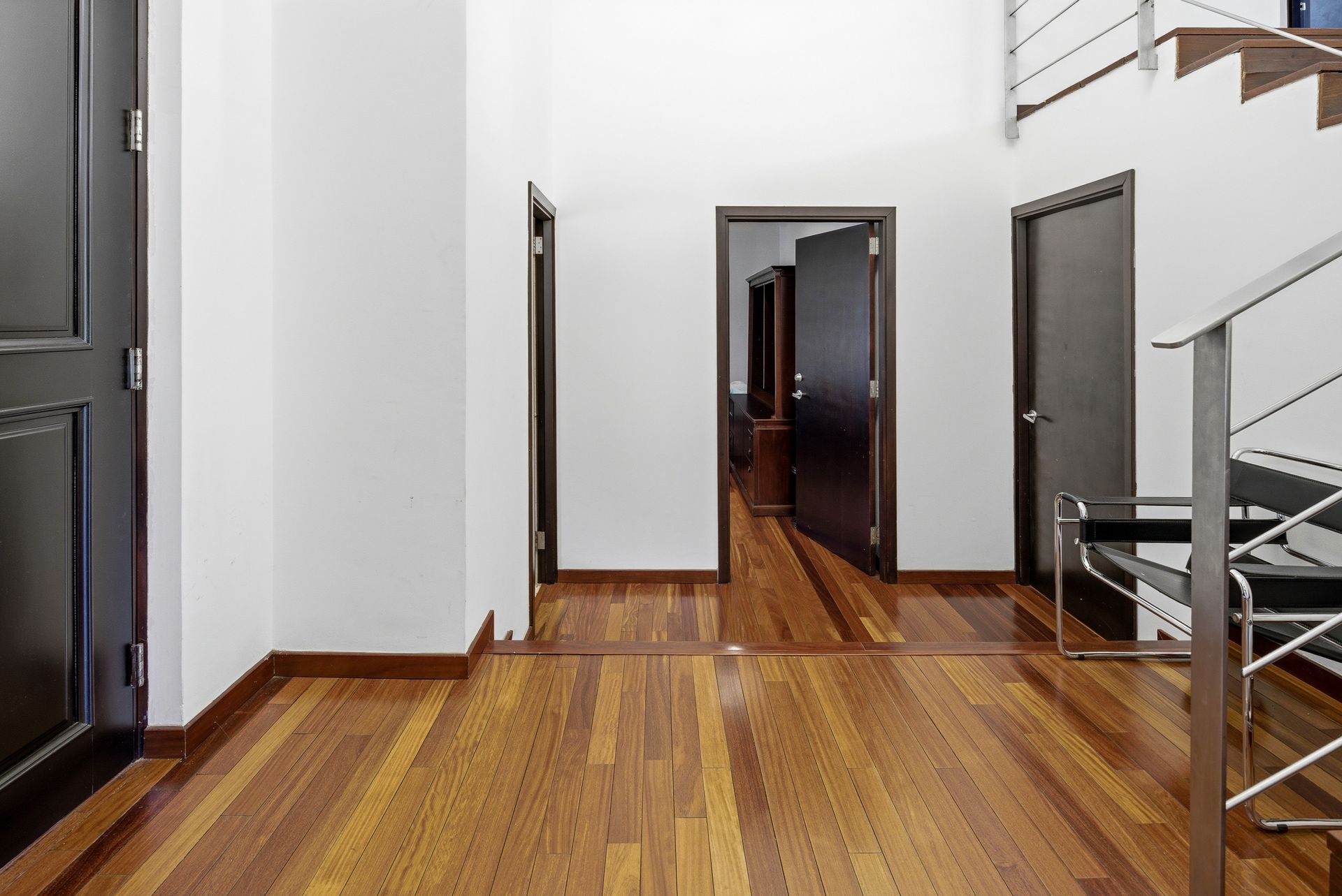 Costa del Este home interior hallway with hardwood flooring and natural light, Panama luxury residence.