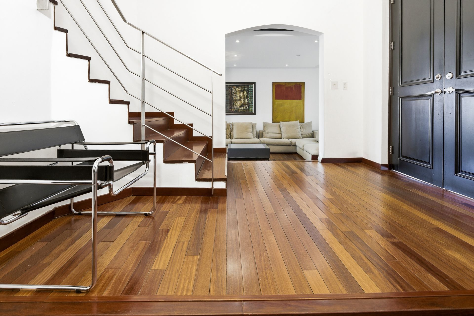 Costa del Este luxury home interior showing staircase connecting to main living area, Panama real estate photograph