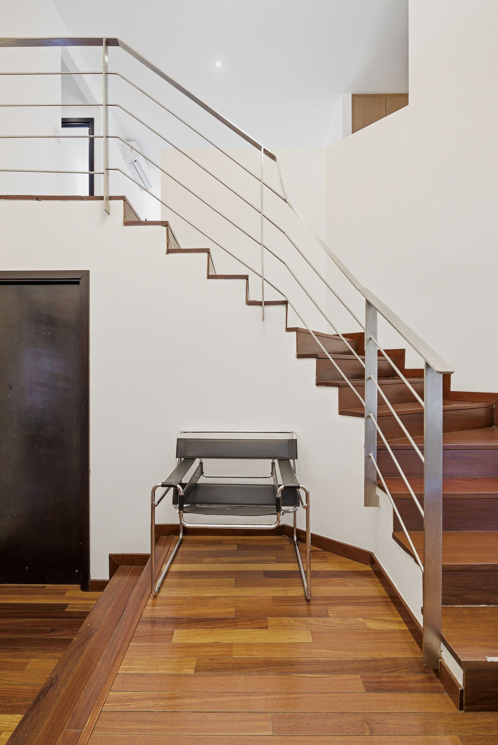 Costa del Este home sculptural wooden staircase with cable railing, Panama luxury architectural photography