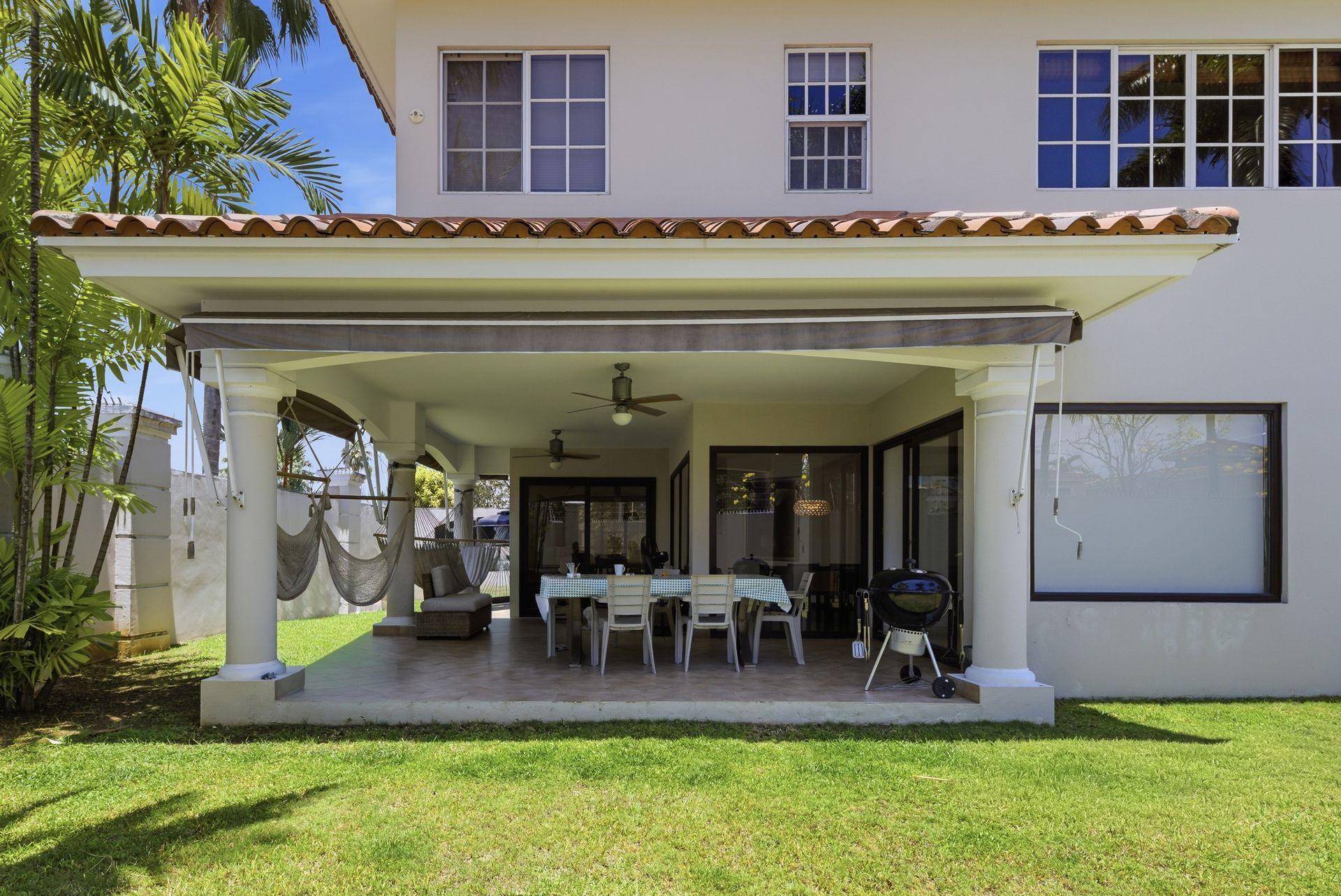 Costa del Este luxury home covered outdoor terrace and entertaining area with garden, Panama real estate photography