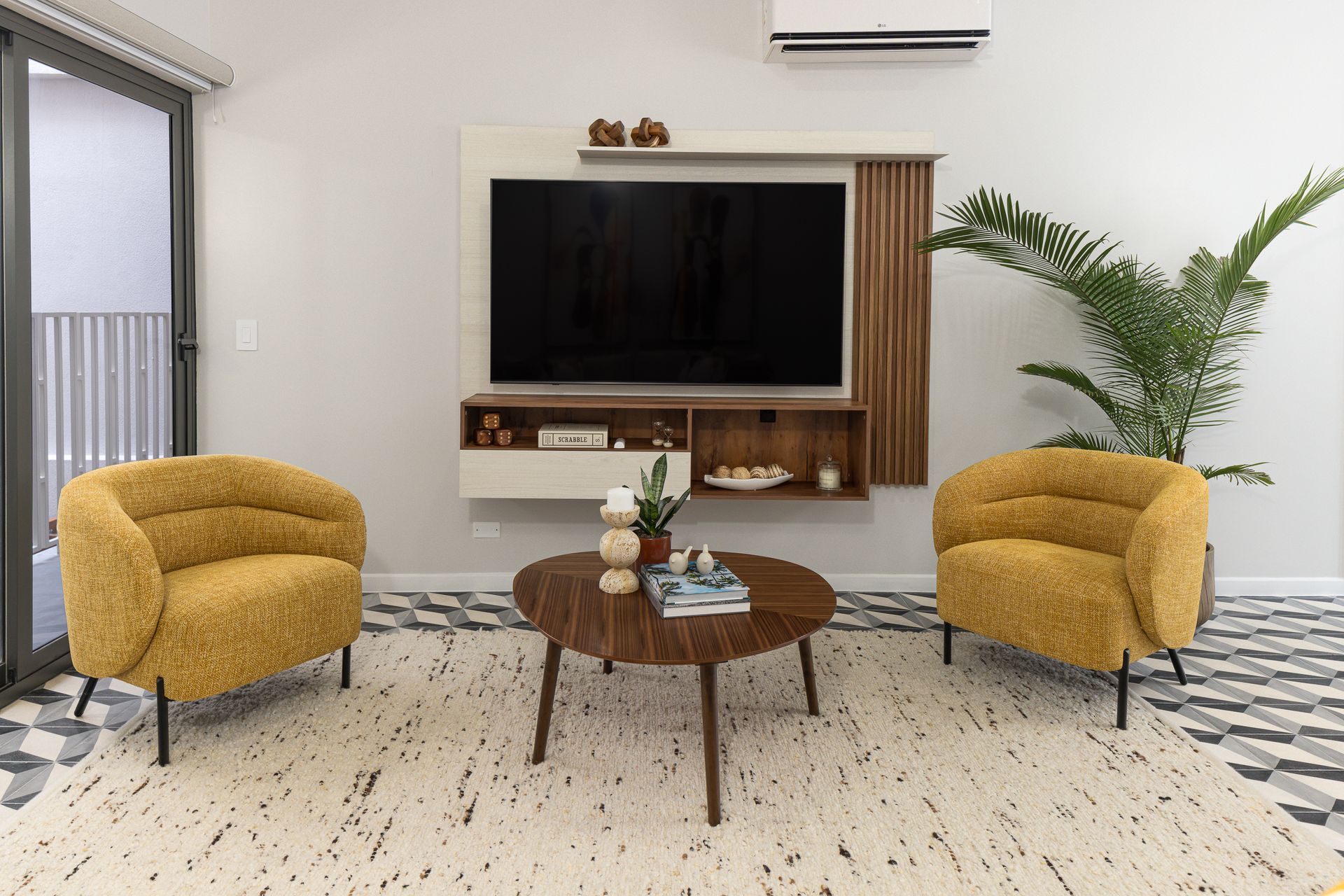 Open concept living area with smart TV and yellow accent chairs in boutique Airbnb Casco Viejo Panama