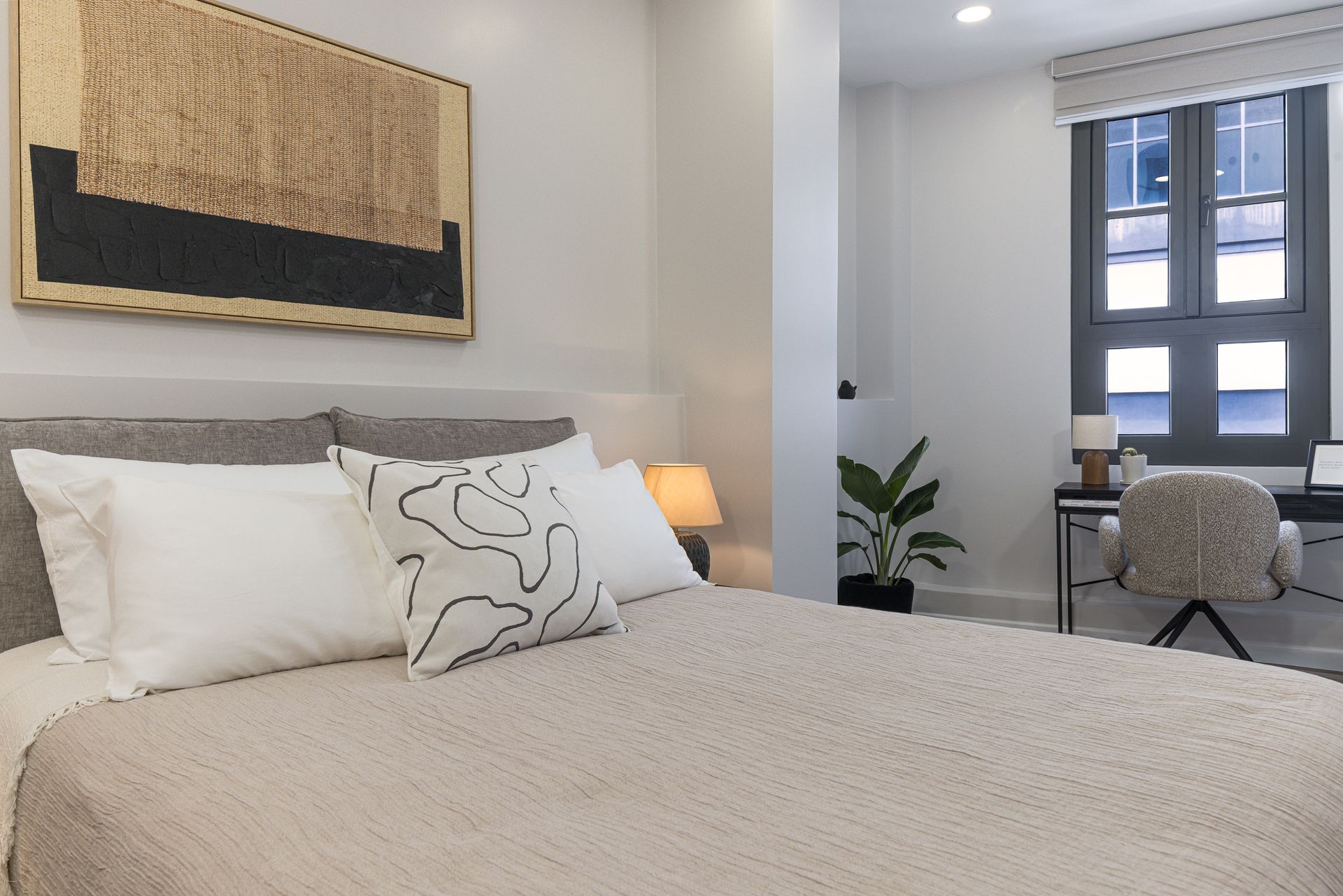 Serene guest bedroom with soft neutral tones and warm lighting in luxury Airbnb Mansión Baluarte Casco Viejo