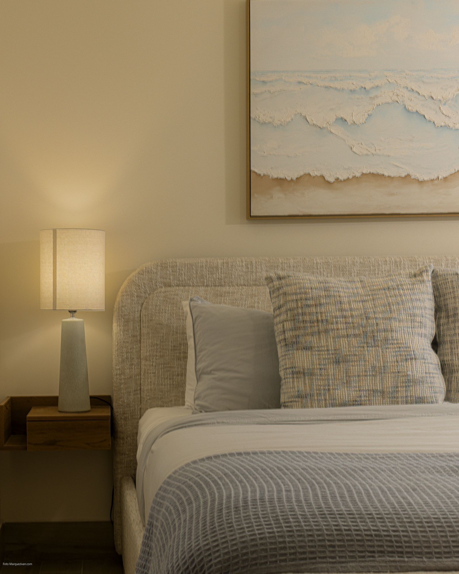 Master bedroom detail of a Playa Caracol apartment with neutral palette and ocean-inspired artwork, interior design by Furnishing Solutions Panama.