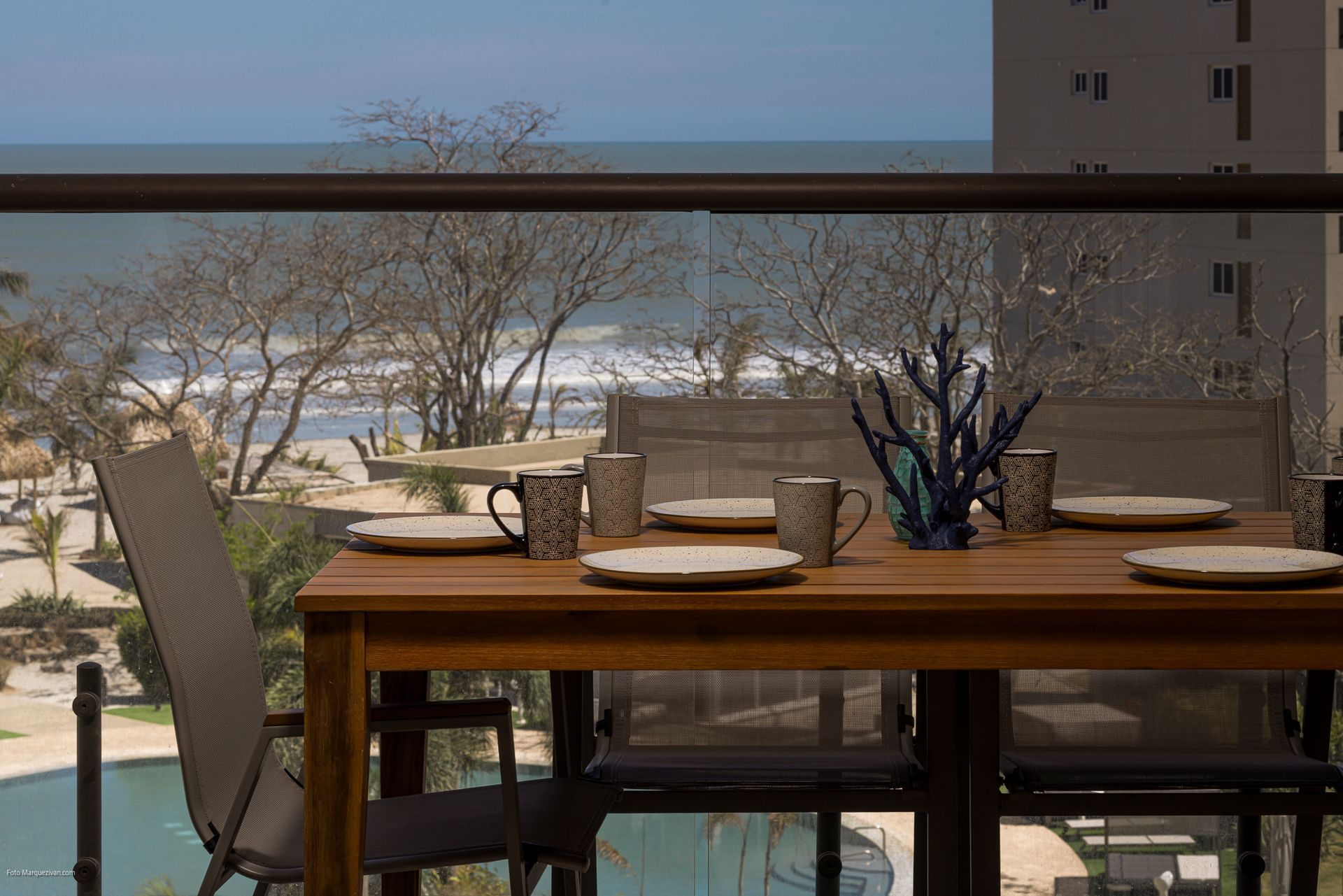 Terrace of a Playa Caracol apartment with outdoor dining table and Pacific Ocean view, styling by Furnishing Solutions Panama.