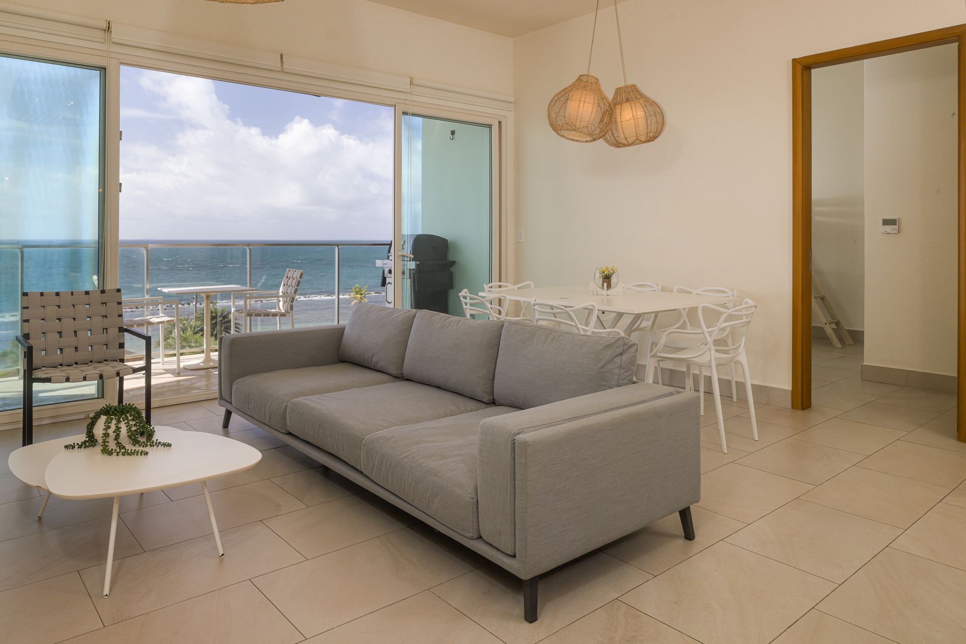 Balcony lounge and dining area with direct Caribbean Sea view at Playa Escondida Resort