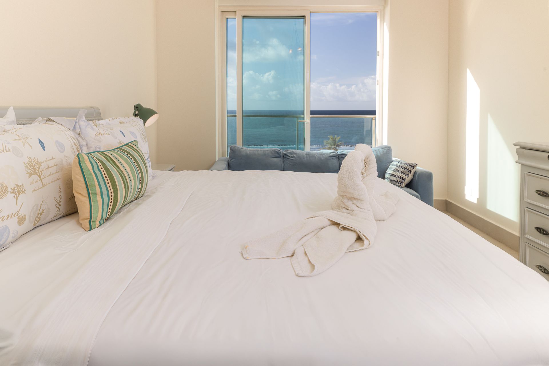 Ocean-view bedroom with bathrobe detail in vacation rental at Playa Escondida, Panama Caribbean