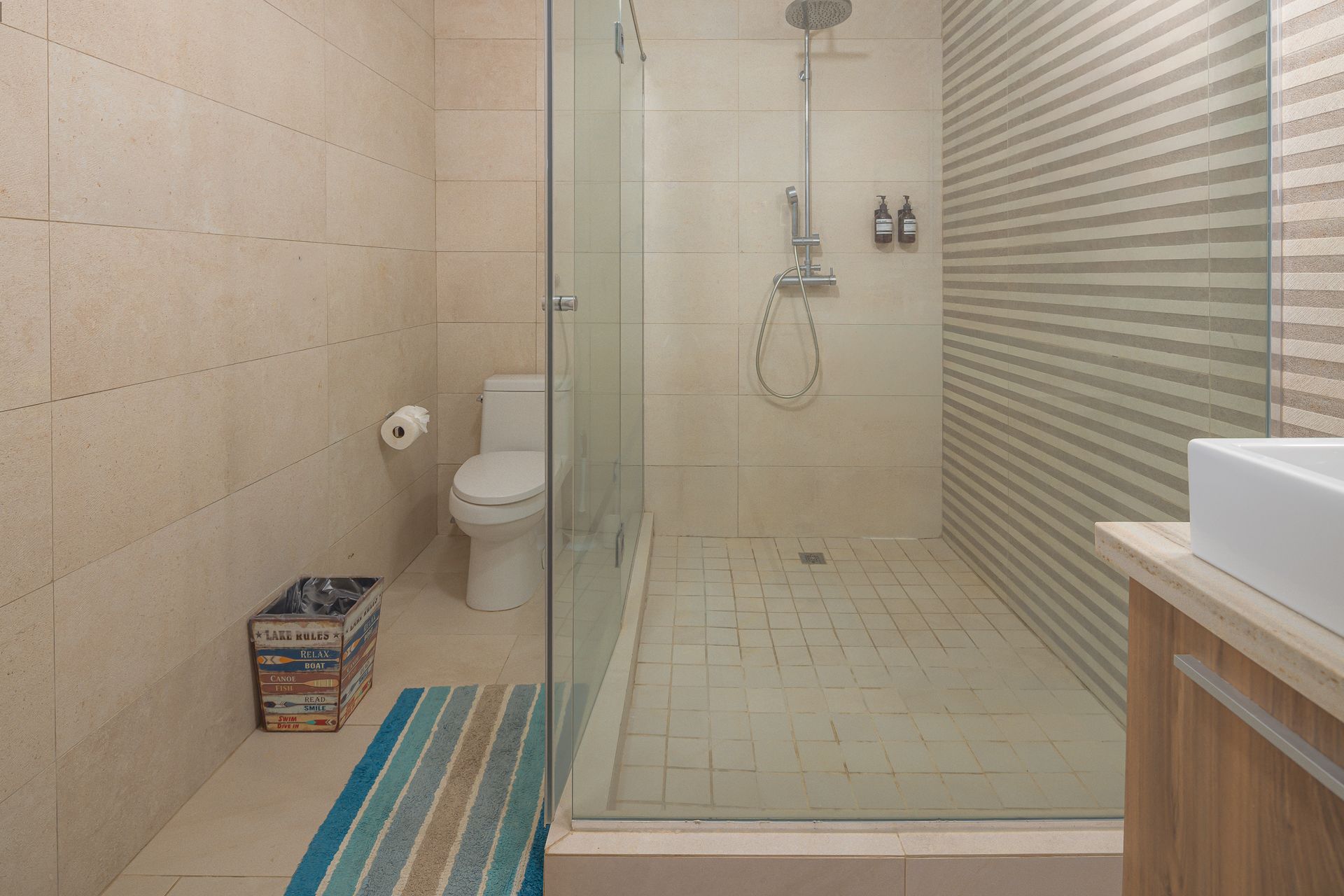 Walk-in rainfall shower with glass enclosure in Airbnb apartment at Playa Escondida Resort