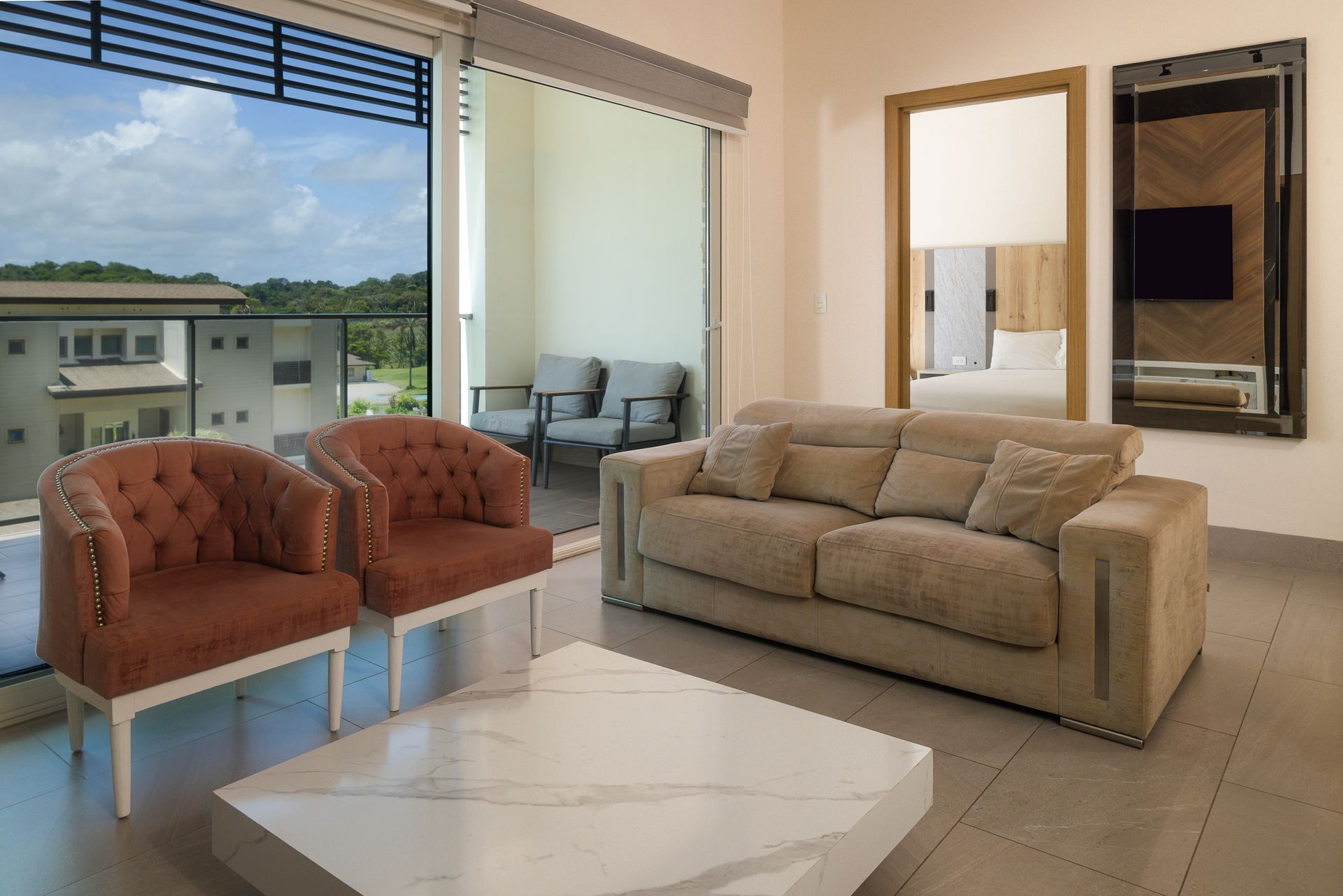 Luxury bedroom interior with neutral tones and historic balcony access in Mansión Baluarte, Casco Viejo.