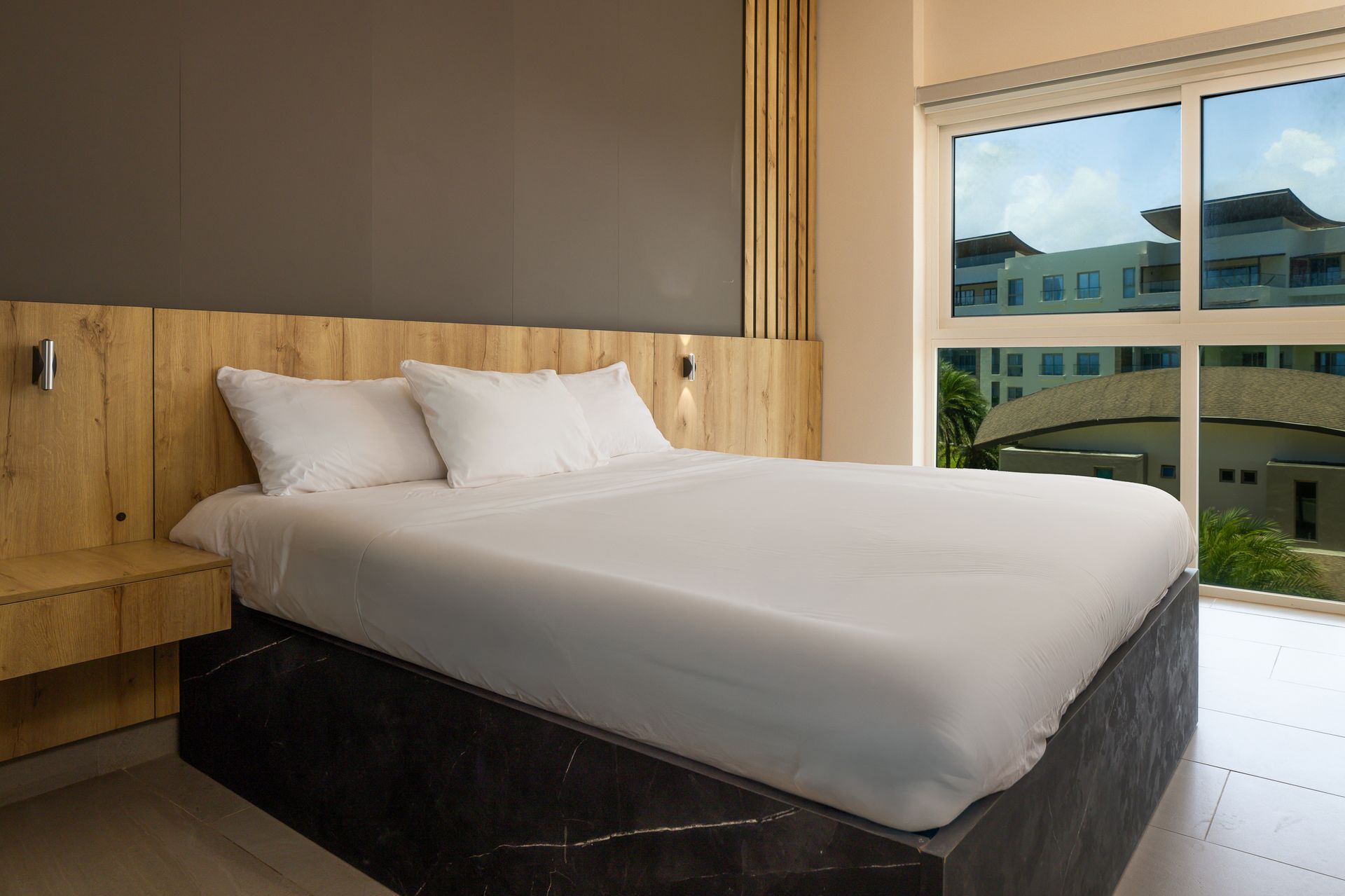 King-size bedroom with dark accent wall in vacation rental at Playa Escondida, Colón, Panama