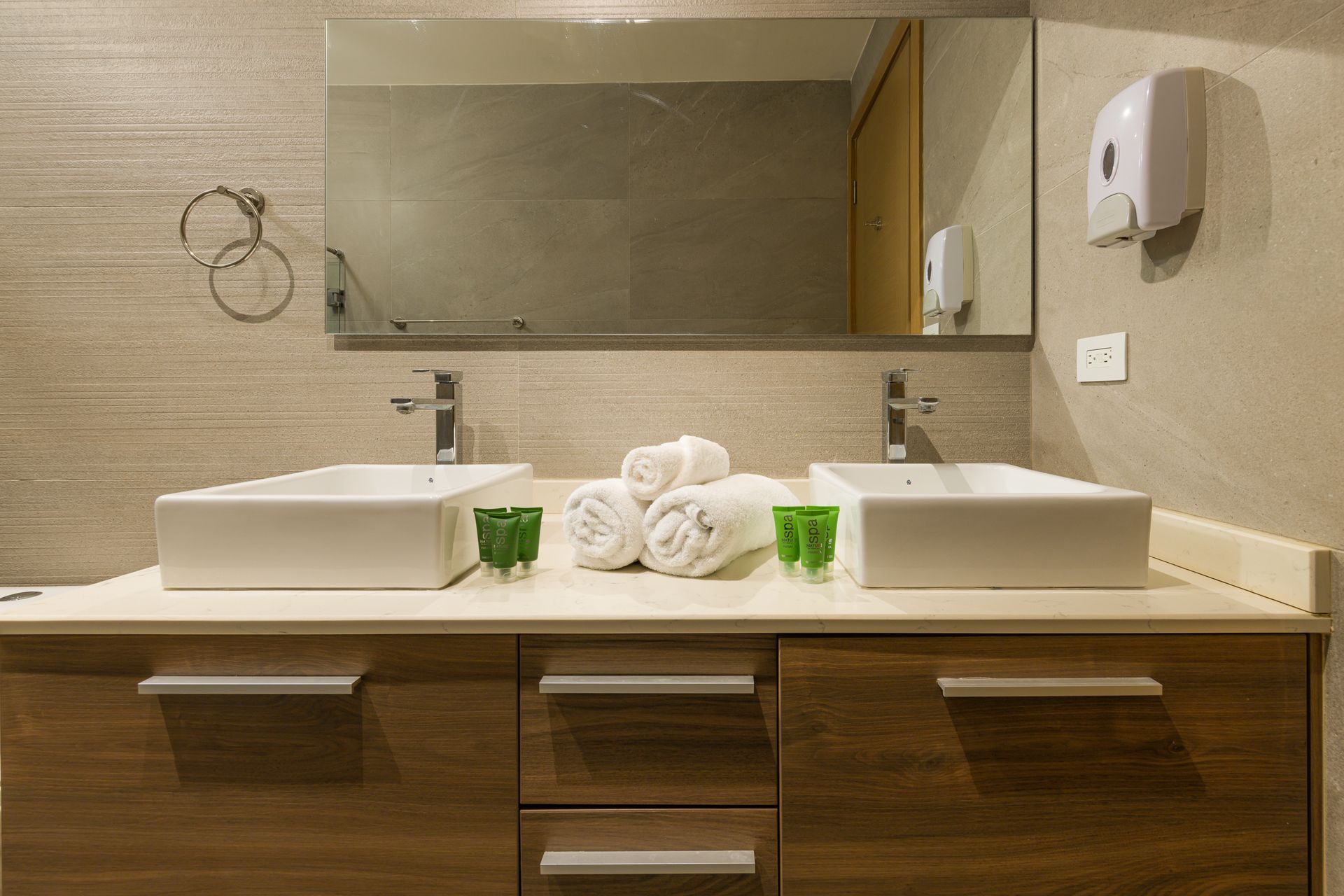 Double-vanity bathroom with wooden cabinetry in Airbnb apartment at Playa Escondida Resort