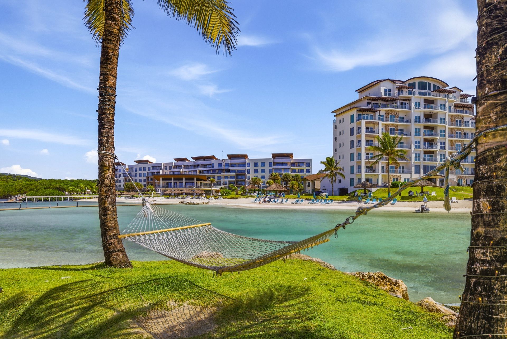 Resort building with infinity pool, palm trees and hammock at Playa Escondida, Panama Caribbean