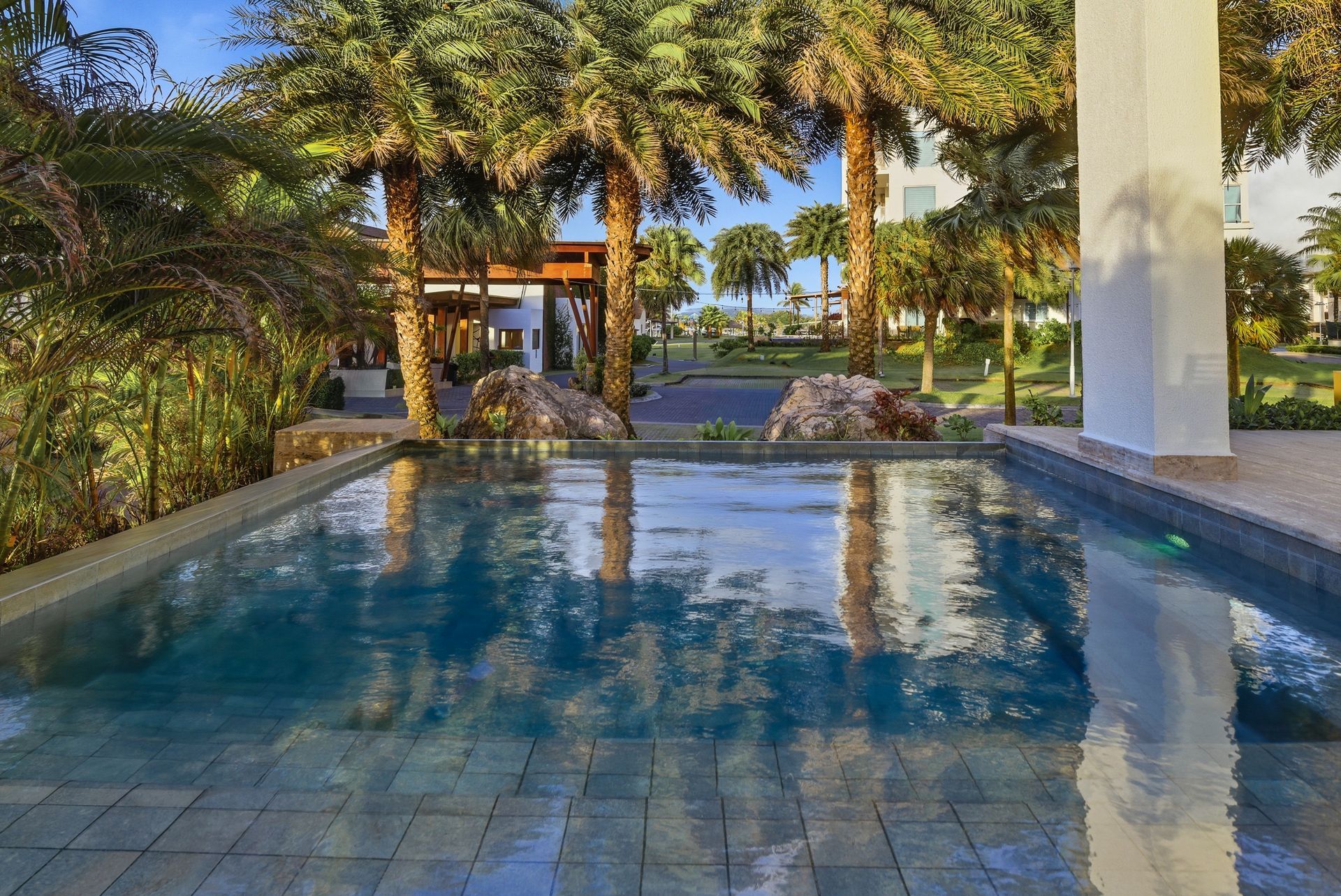 Tropical resort pool with lush landscaping at Playa Escondida Resort, Colón, Panama