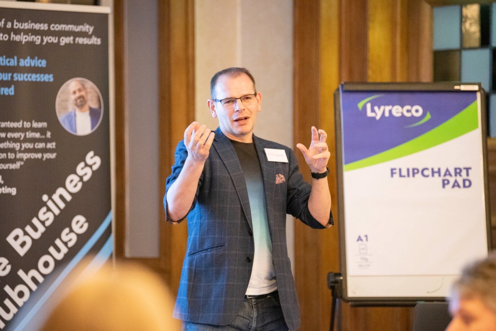 A man is giving a presentation in front of a lyreco flipchart pad
