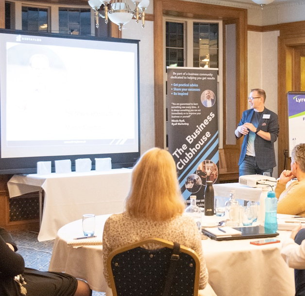 A man is giving a presentation at the business clubhouse