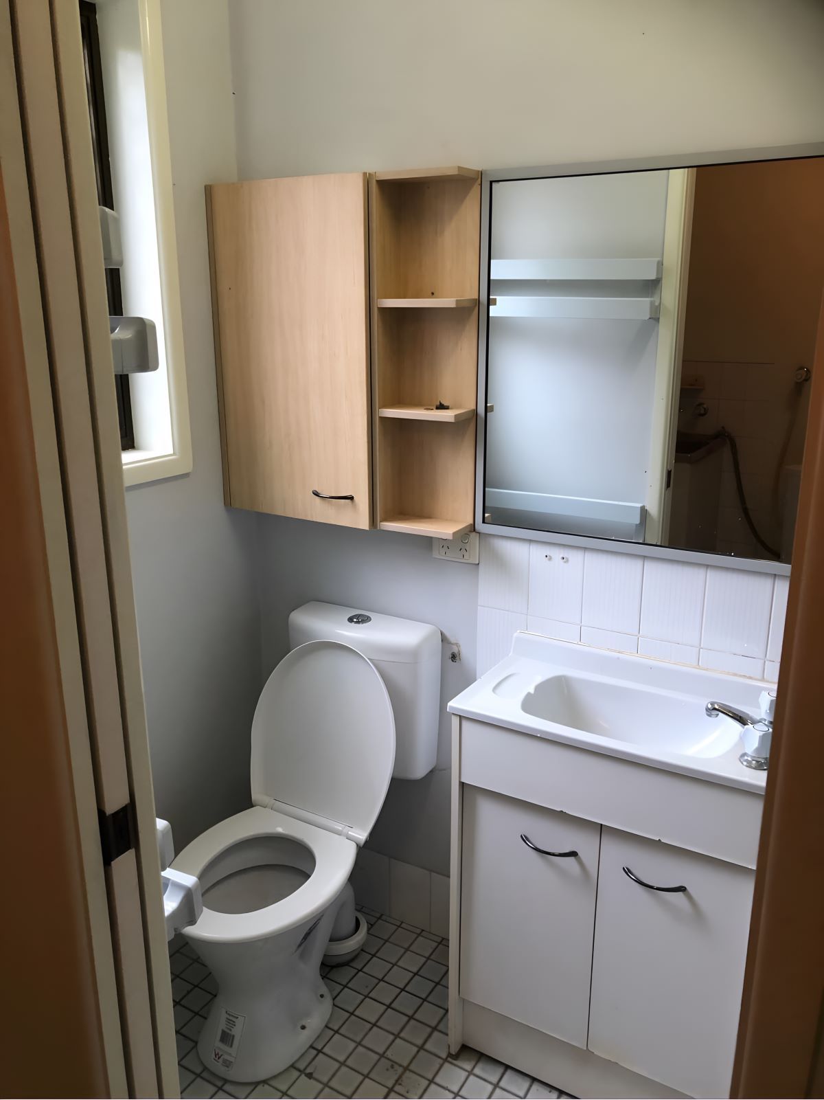 A Bathroom Equipped With A Toilet, Sink, And Mirror — Coffs Coast Designer Bathrooms in Woolgoolga, NSW