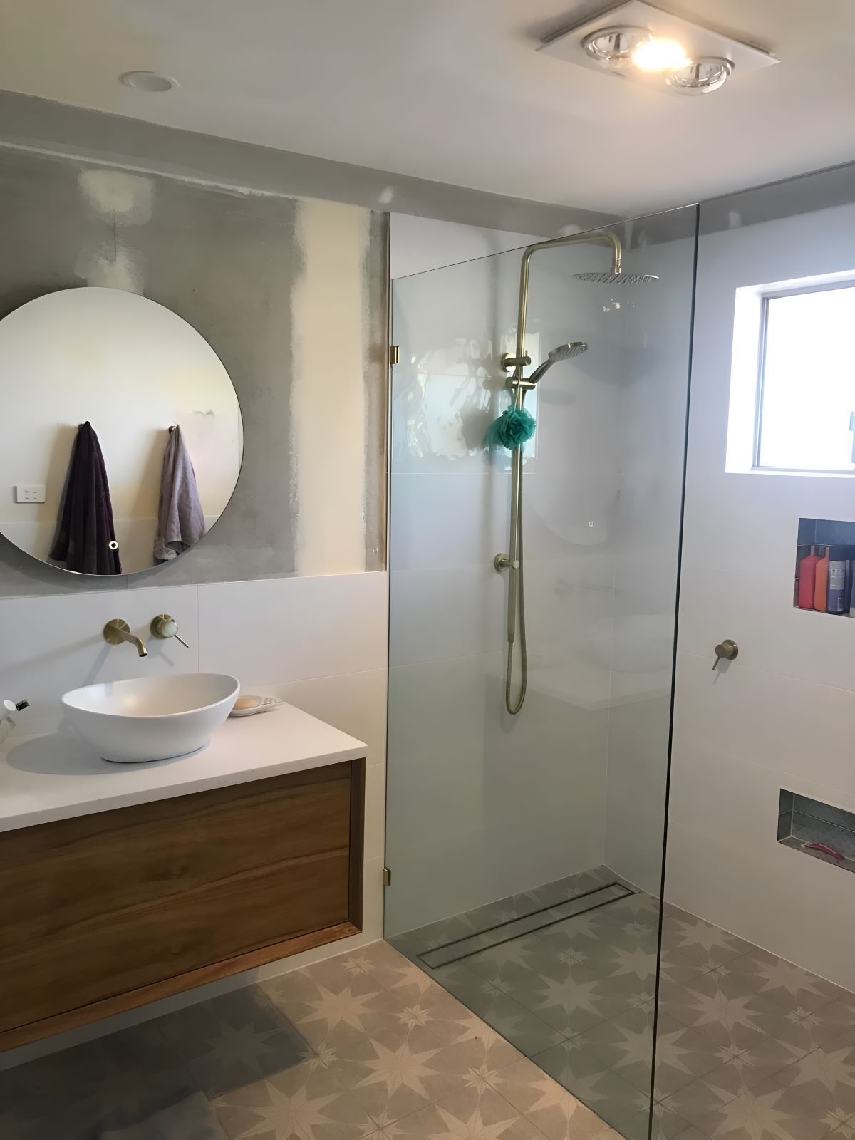A Bathroom With Shower And Circle Mirror — Coffs Coast Designer Bathrooms in Urunga, NSW