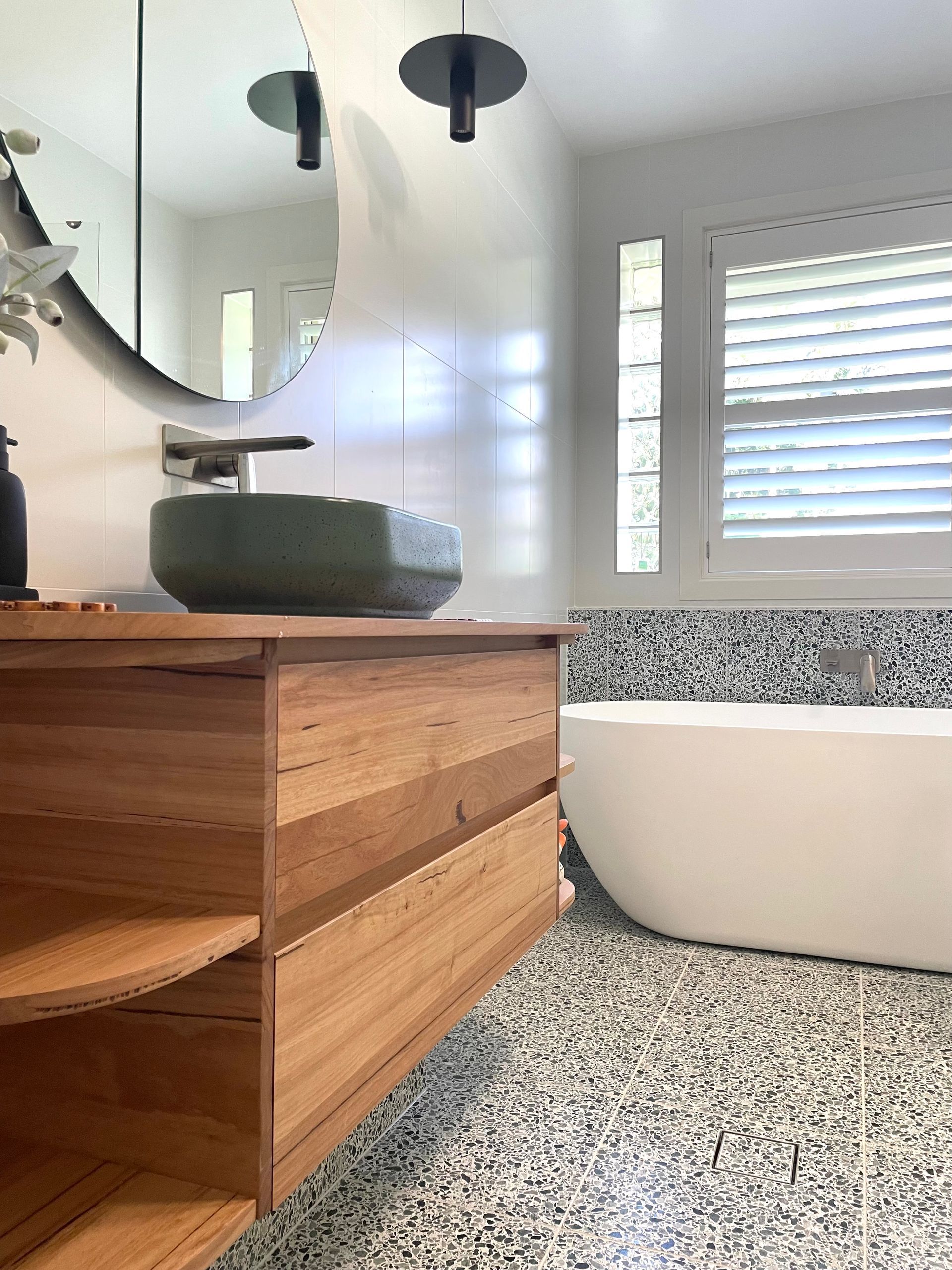 A Bathroom With A Sink, Bathtub, Mirror And Window — Coffs Coast Designer Bathrooms in Toormina, NSW