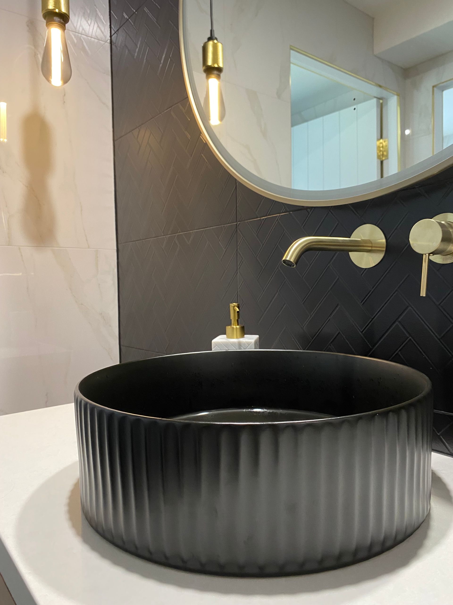 A Bathroom With A Black Sink And A Mirror — Coffs Coast Designer Bathrooms in Toormina, NSW