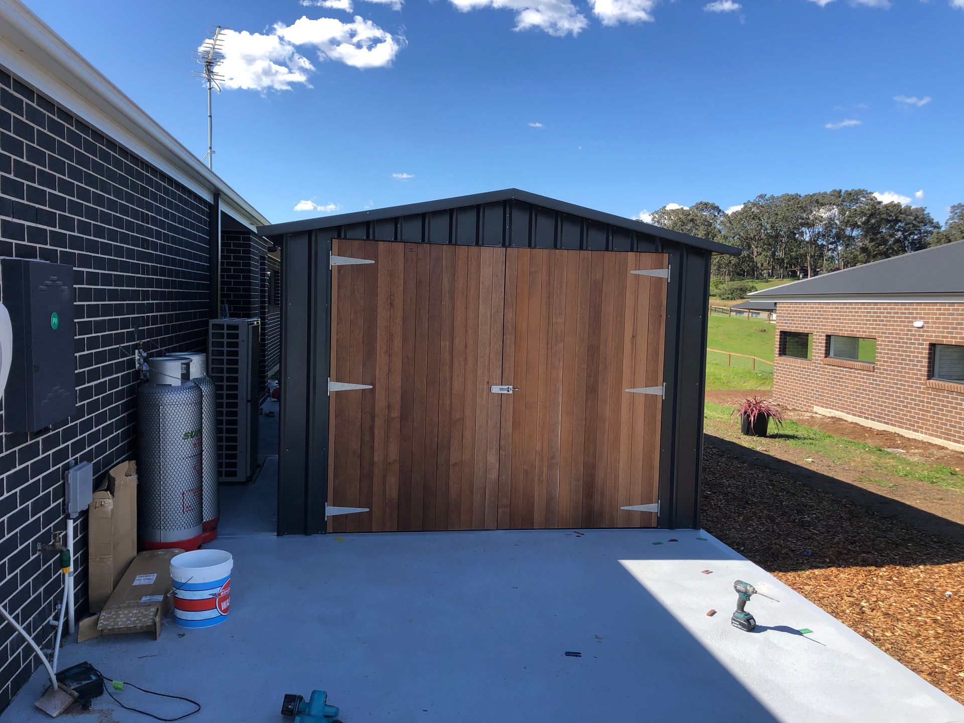 A Person Is Fixing a Door with A Drill — Highline Carpentry in Kahibah, NSW