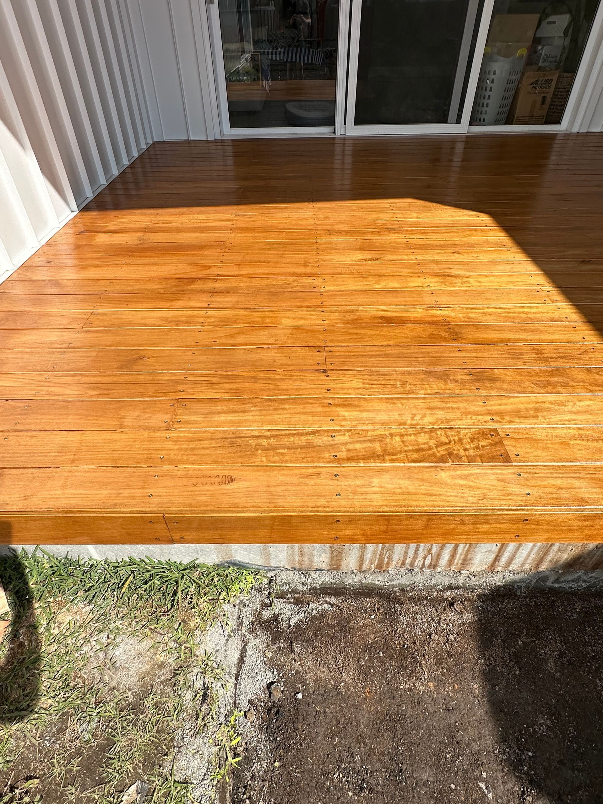 A Man Is Working on A Wooden Deck — Highline Carpentry in Kahibah, NSW