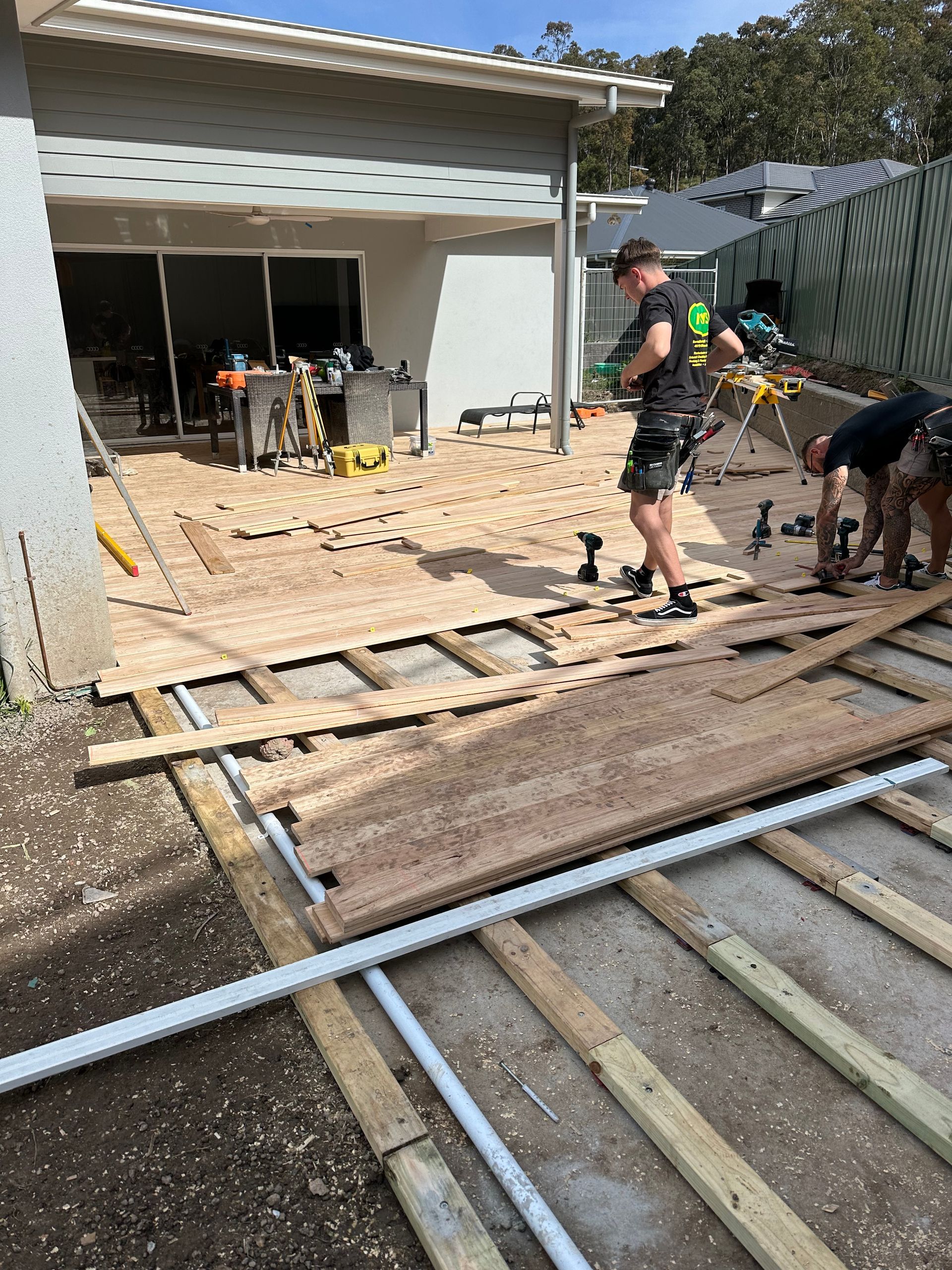 A Group of Men Are Working on A Wooden Structure — Highline Carpentry in Kahibah, NSW
