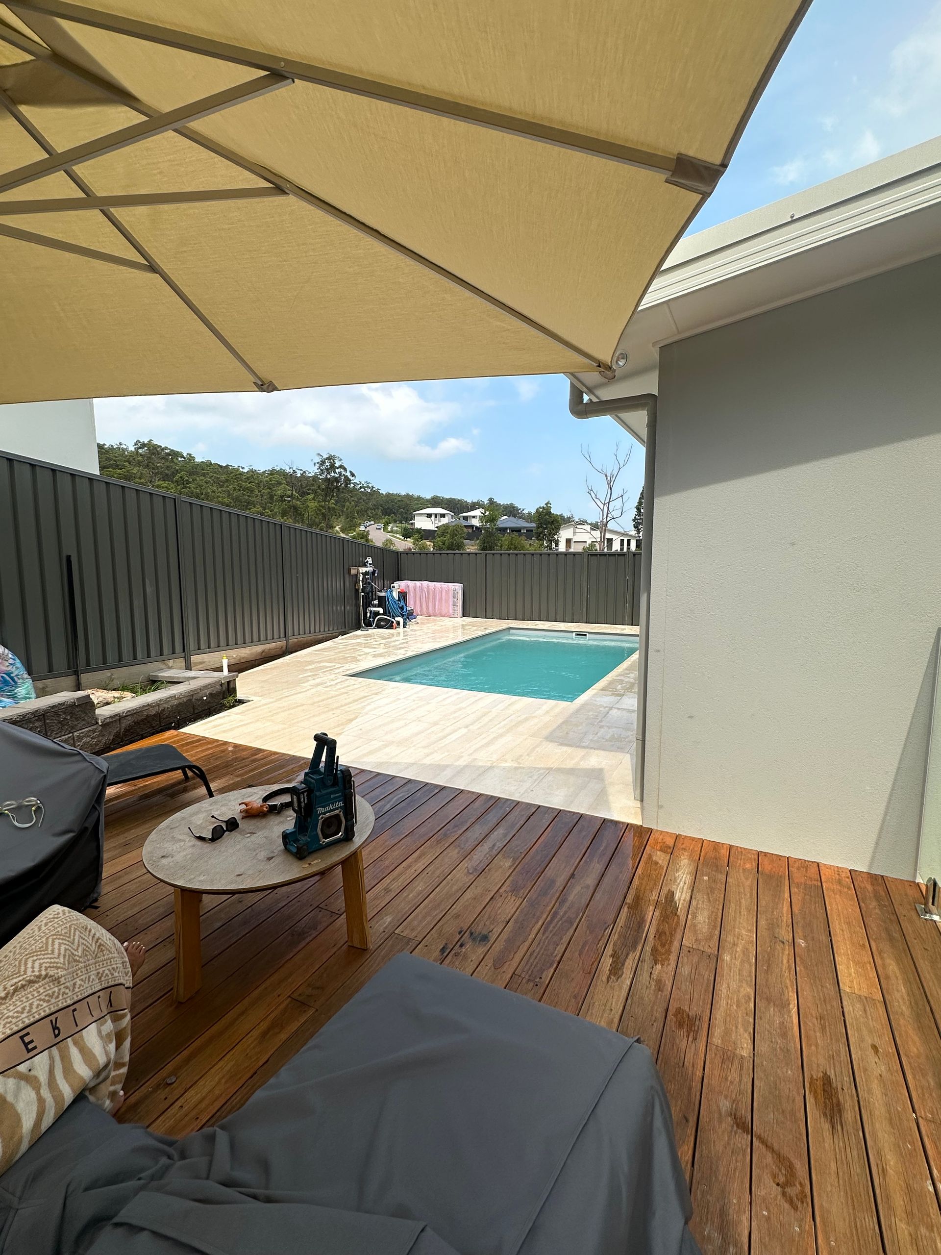 A Man Is Measuring a Piece of Wood on A Table — Highline Carpentry in Kahibah, NSW