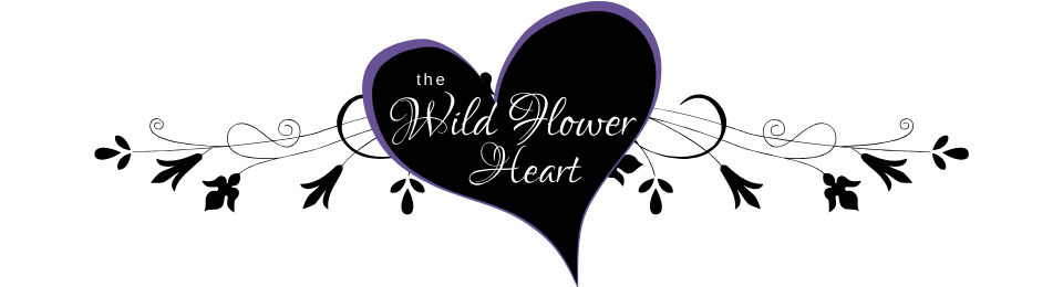 A black heart with the words `` wild flower heart '' written on it