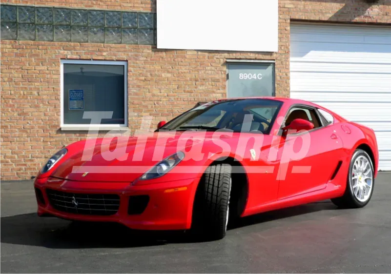 A red ferrari is parked in front of a brick building