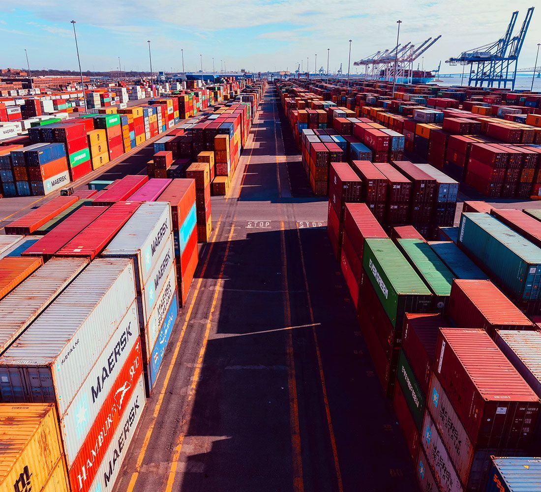 An aerial view of a warehouse filled with lots of shipping containers.