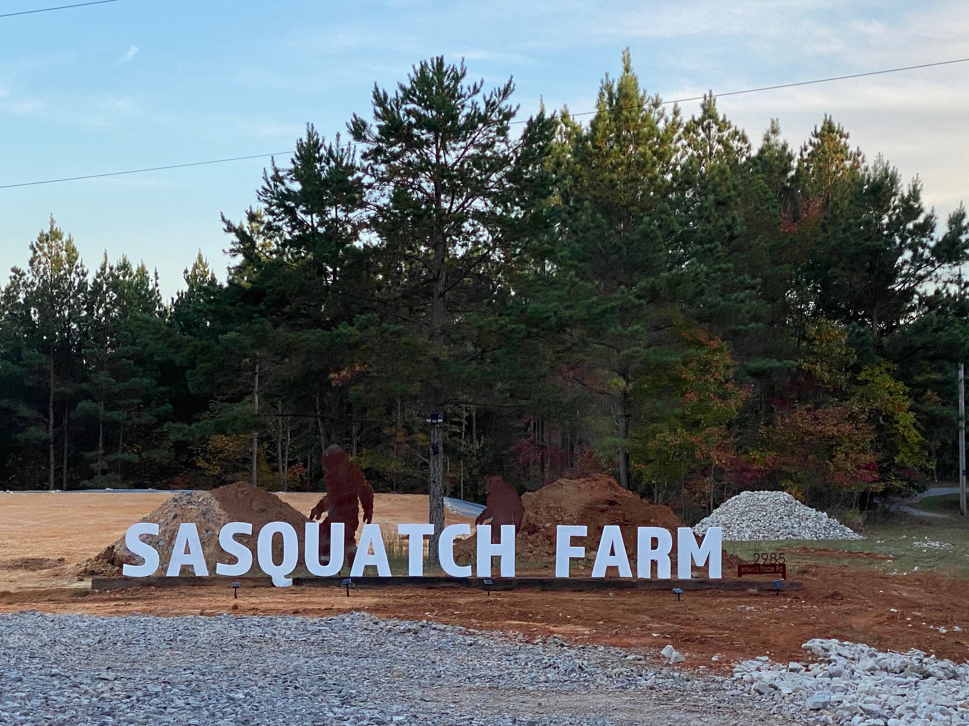 A large sign that says sasquatch farm on it
