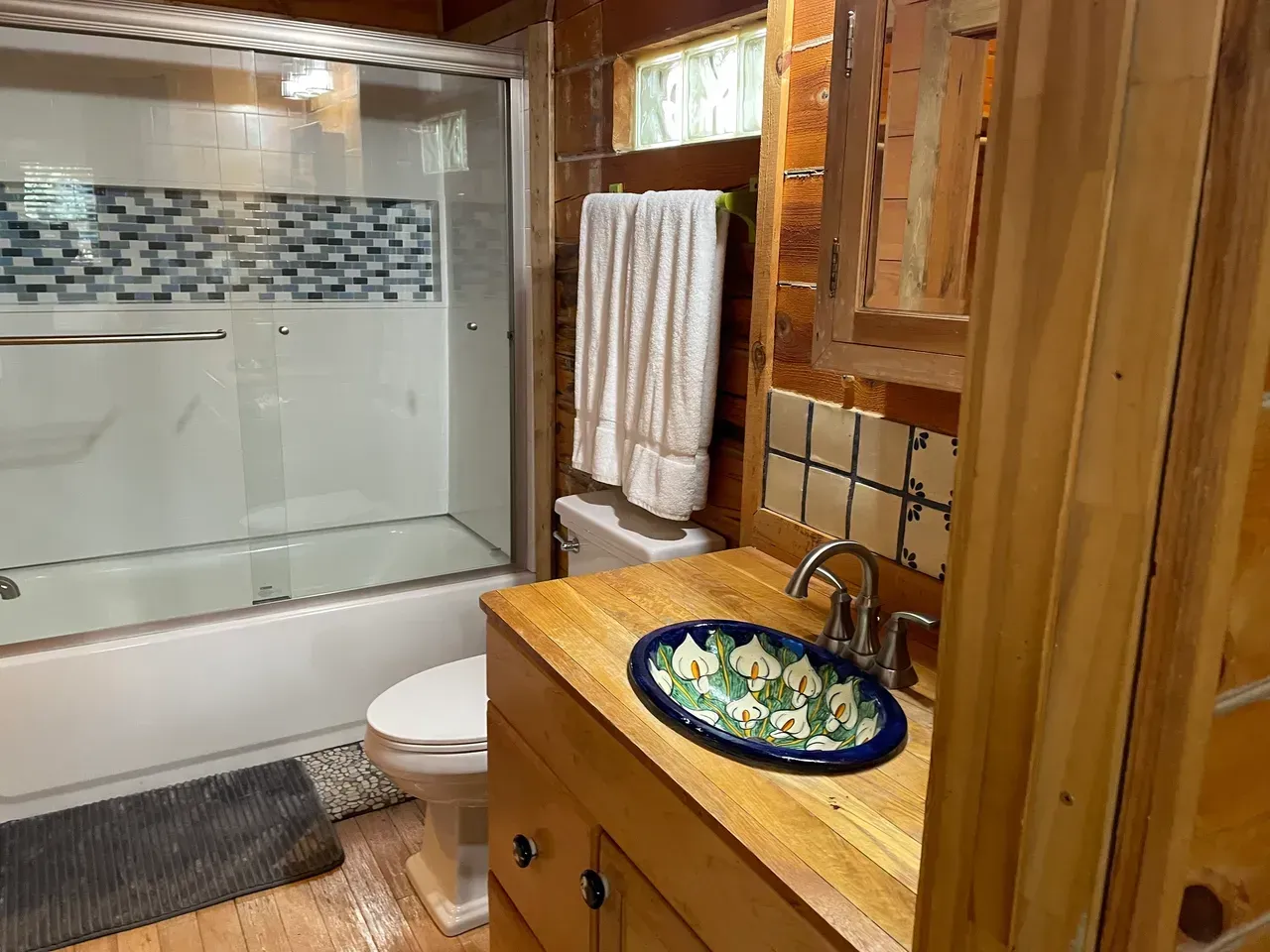 A bathroom with a sink , toilet , tub and shower.