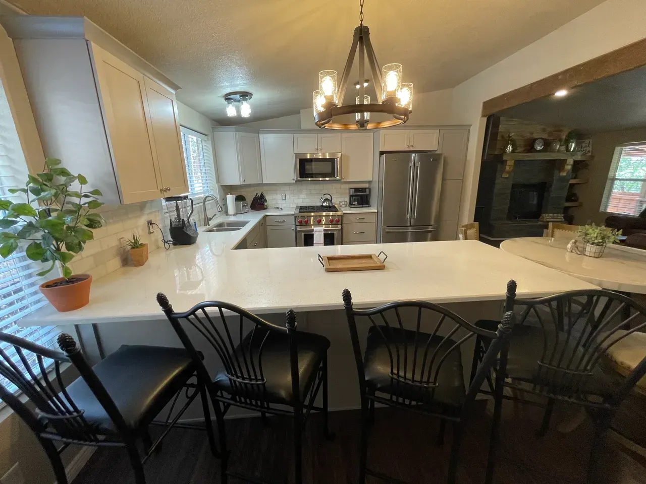 A kitchen with a table and chairs and a chandelier
