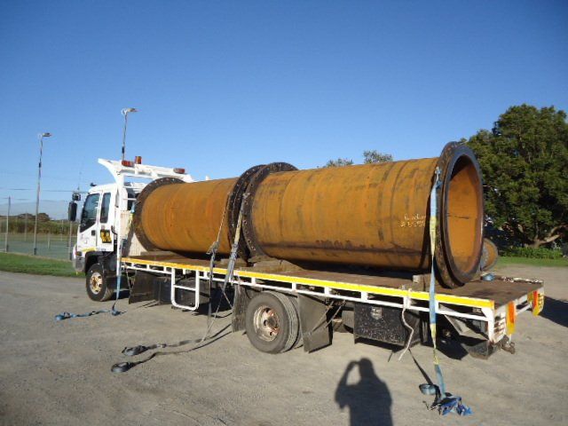 A Large Pipe Is On The Back Of A Truck — Origin Group in Paget, QLD