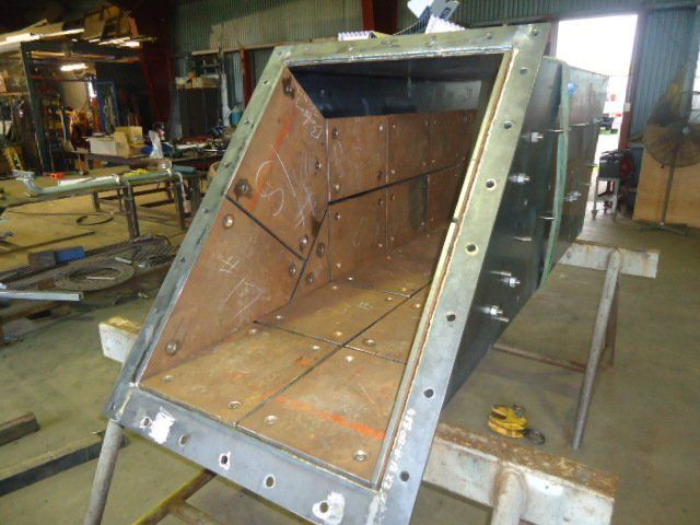 A Piece Of Metal Is Sitting On A Table In A Factory — Origin Group in Paget, QLD