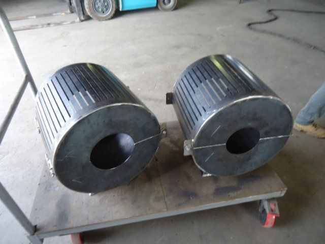 Two Metal Cylinders With Holes In Them Are On A Cart — Origin Group in Paget, QLD