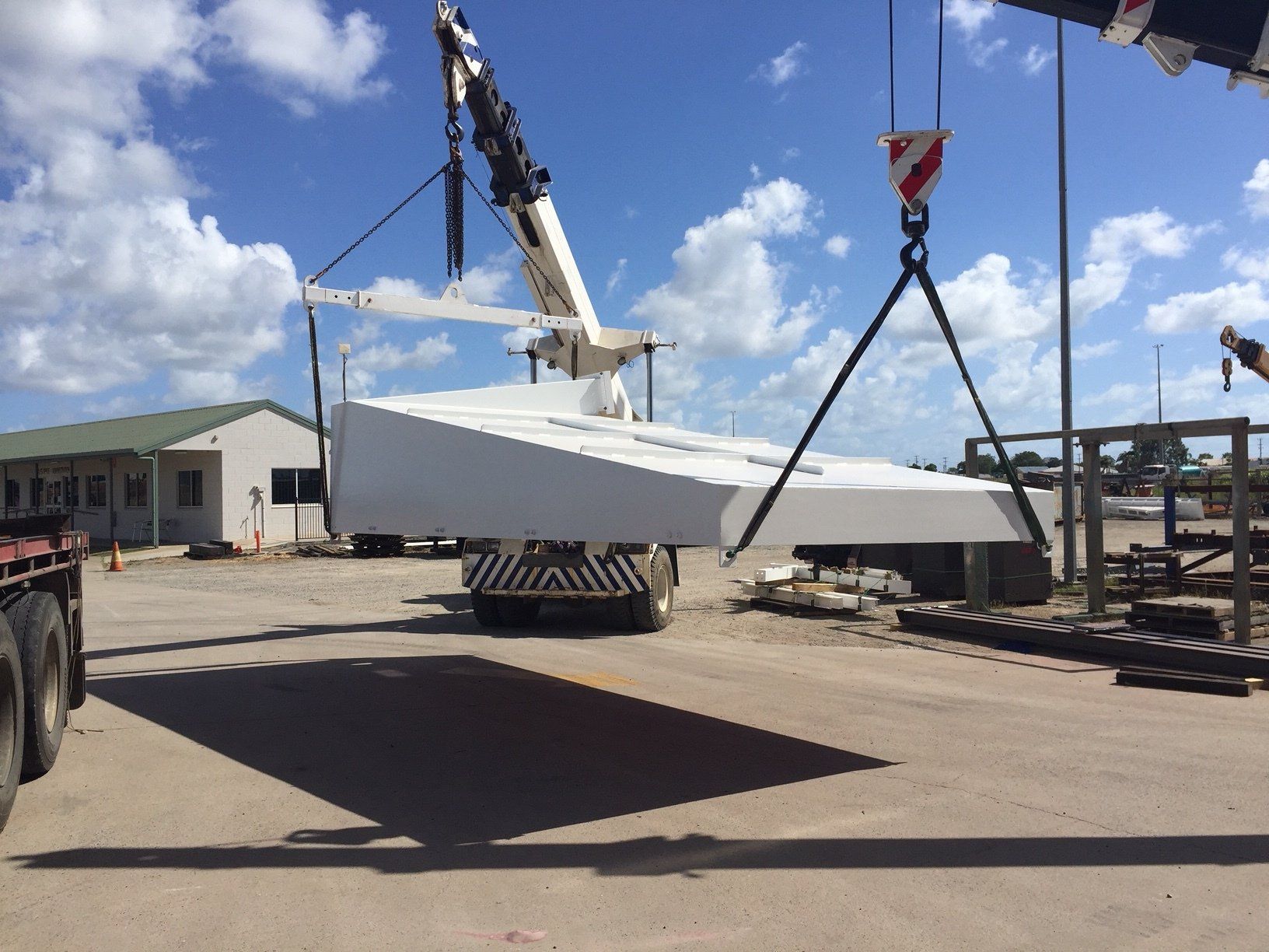 A Large White Object Is Being Lifted By A Crane — Origin Group in Paget, QLD