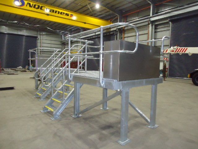 A Metal Platform With Stairs And A Yellow Crane In The Background — Origin Group in Paget, QLD