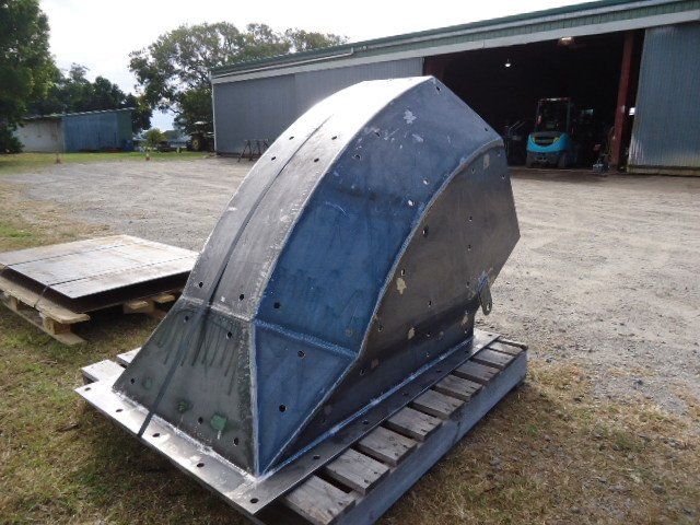 A Large Piece Of Metal Is Sitting On A Wooden Pallet In Front Of A Building — Origin Group in Paget, QLD