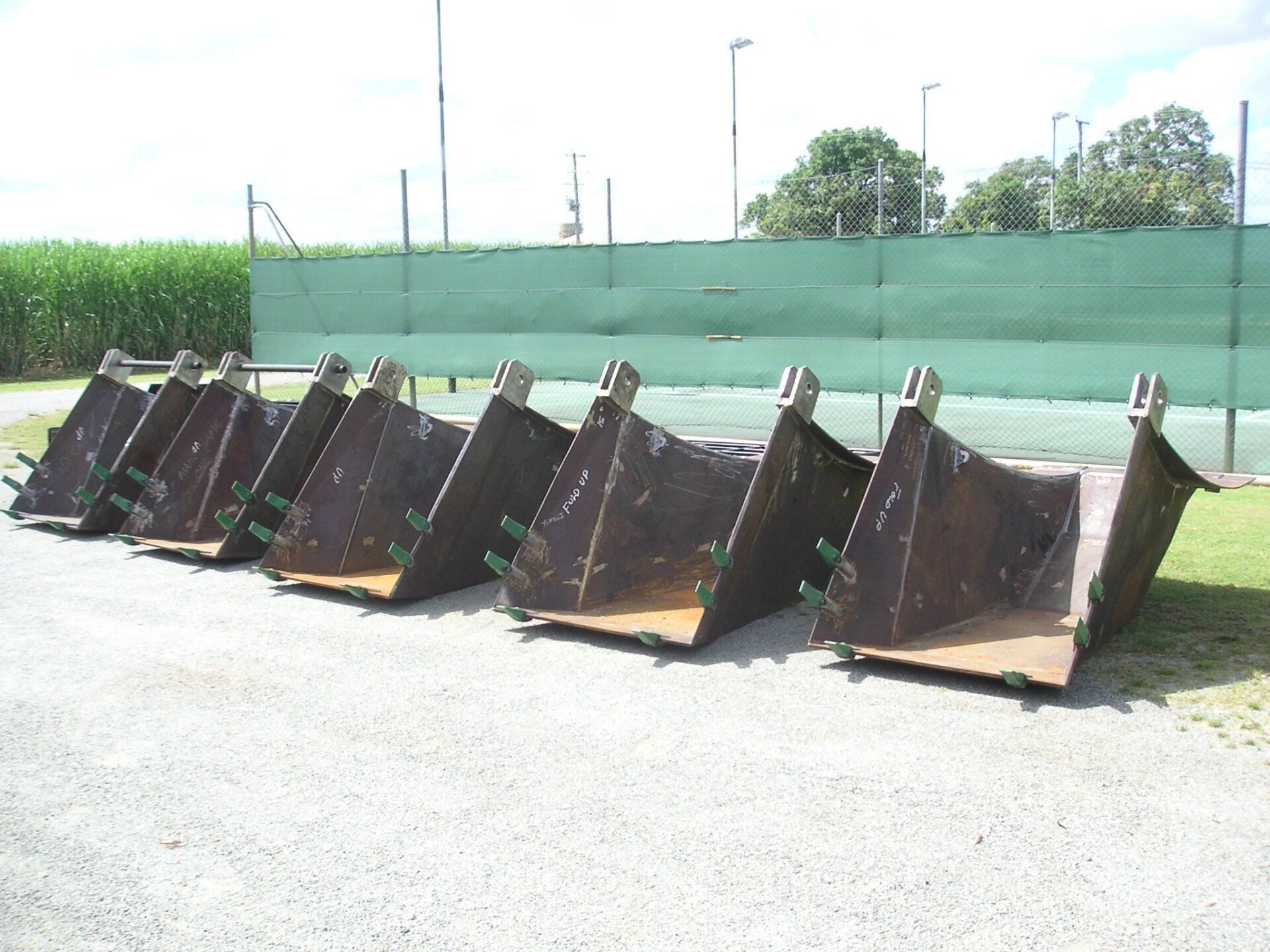 A Bunch Of Buckets Are Lined Up In A Row — Origin Group in Paget, QLD